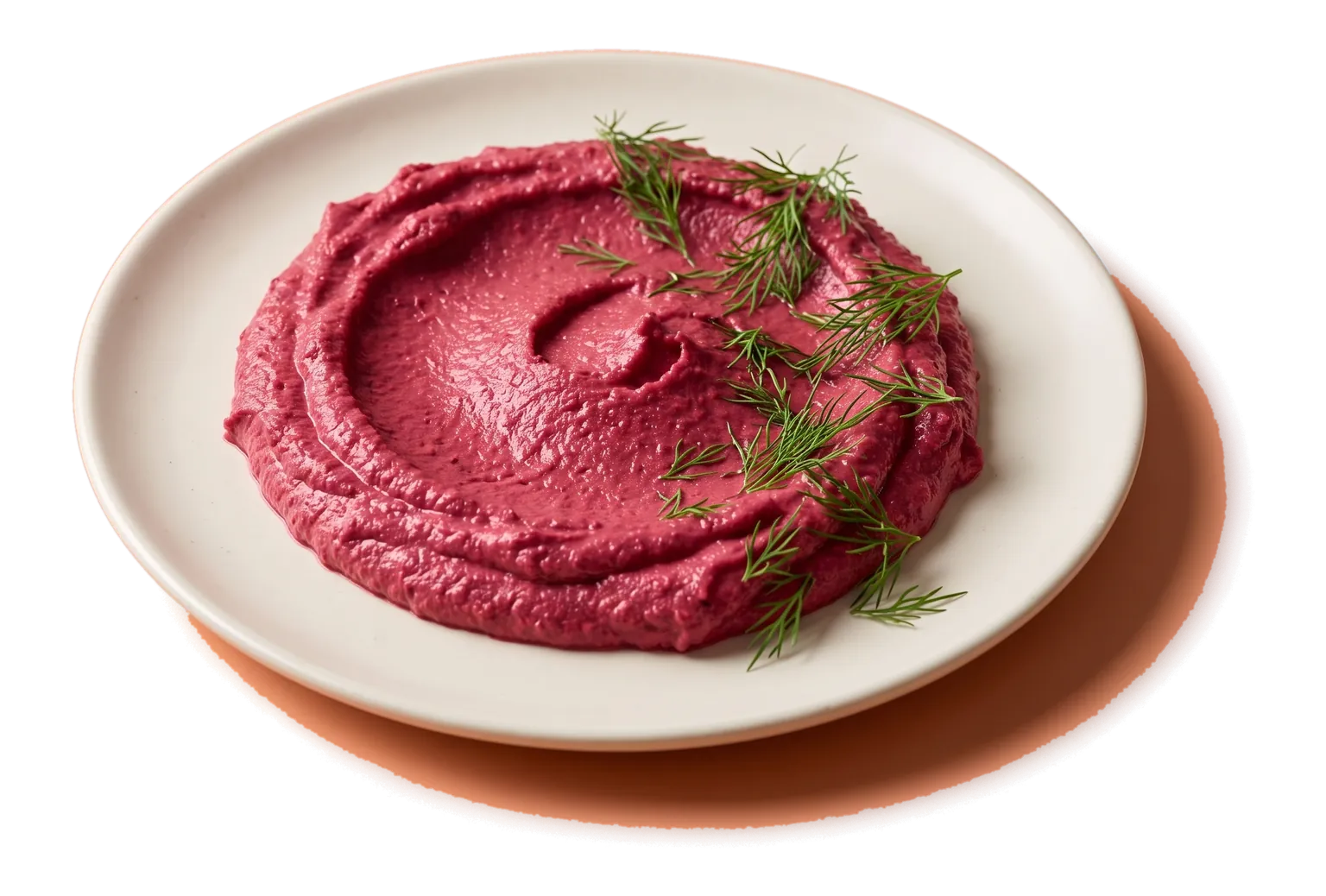 A flat plate of smooth pink hummus with a swirl drawn in it by a spoon and sprigs of dill on top