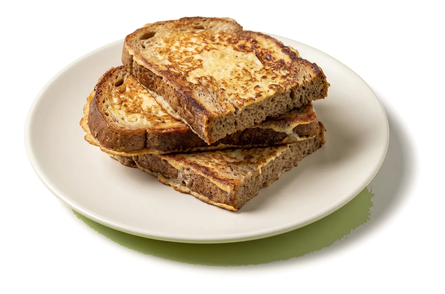 A stack of golden slices of rye bread French toast on a flat plate